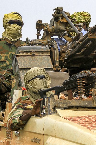 TOPSHOT - Fighters ride in a vehicle moving in a military convoy accompanying the governor of Sudan's Darfur State during a stopover in the eastern city of Gedaref while on the way to Port Sudan on August 30, 2023. (Photo by AFP) (Photo by -/AFP via Getty Images)